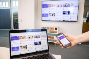 Business owner viewing website, Google Business Profile, and social media together on a laptop