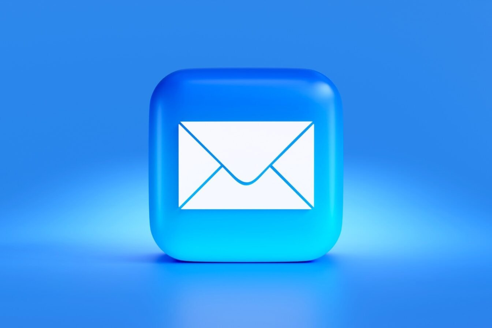 Business owner managing email marketing alongside website and social media on a laptop
