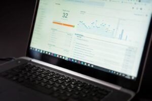 Business owner analyzing video performance metrics on a laptop
